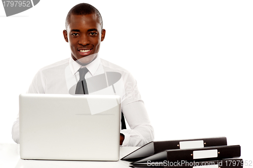 Image of African corporate male manager at work desk