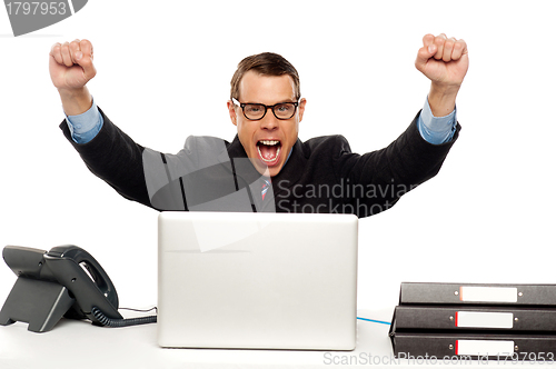 Image of Excited businessman shouting and rejoicing