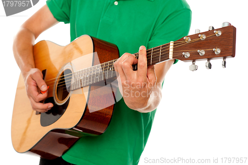 Image of Cropped image of a man playing guitar