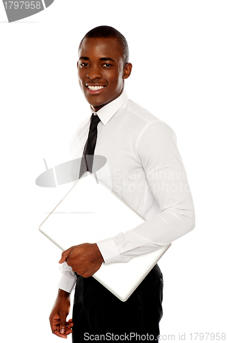 Image of African businessman carrying laptop