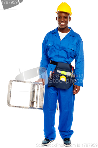 Image of African repairman holding stepladder