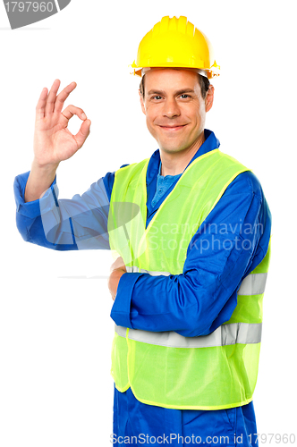 Image of Handsome young worker gesturing okay sign