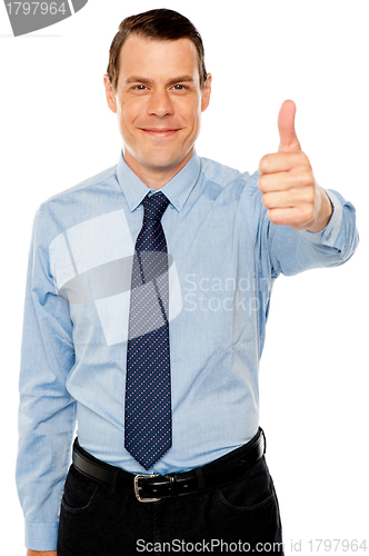 Image of Smiling young man with thumbs up gesture