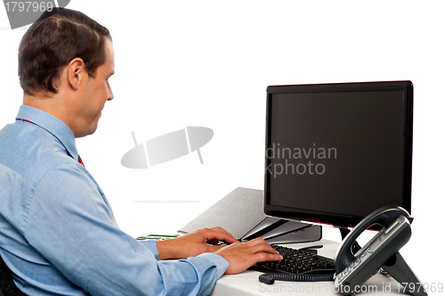 Image of Side view male accountant working in office