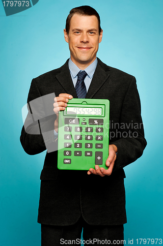 Image of Corporate guy showing big green calculator