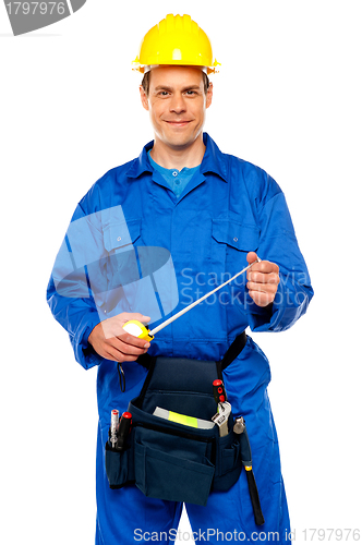 Image of Smiling male worker wearing yellow safety hat