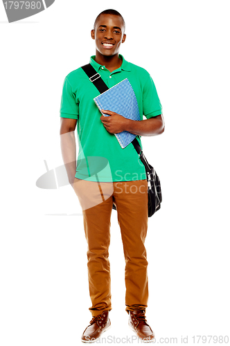 Image of Student carrying laptop bag and notebook