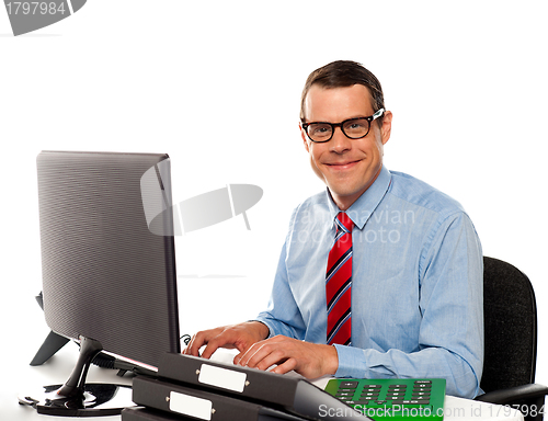 Image of Happy young corporate man using computer