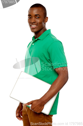 Image of Casual teenager carrying laptop