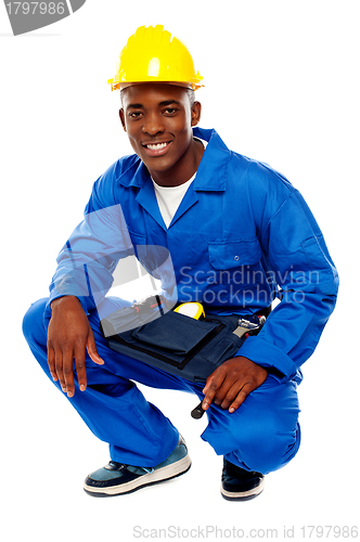 Image of Seated african worker posing with a smile