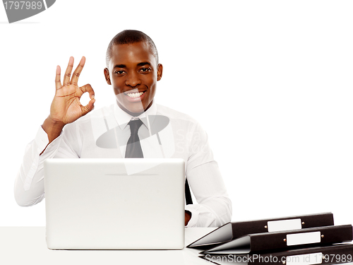 Image of Smiling african male showing excellent symbol