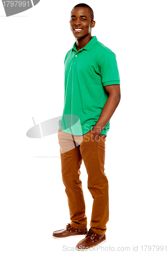 Image of Casual young guy posing with hands in pocket