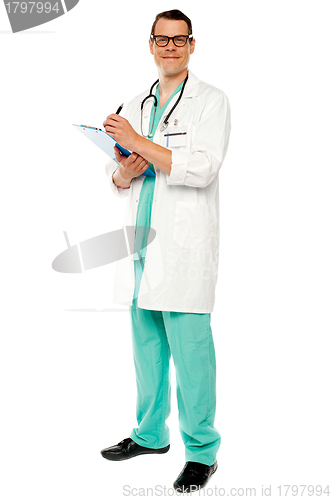 Image of Full length portrait of doctor writing prescription