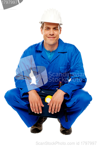 Image of Smiling male worker wearing safety hat