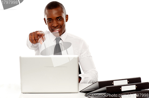 Image of Confident businessman pointing at you