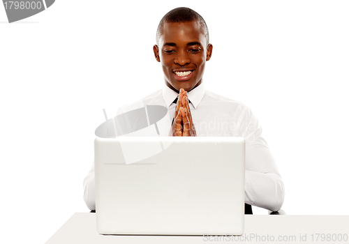 Image of Cheerful manager looking at laptop screen