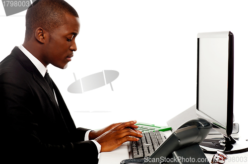 Image of Side view male secretary typing on keyboard