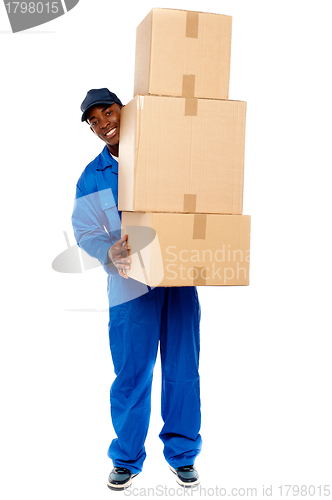 Image of Delivery boy carrying heavy boxes