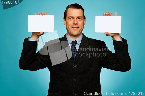 Image of Businessman showing two blank white placards