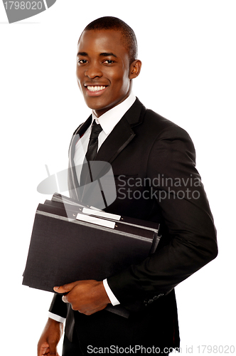 Image of Handsome young executive holding files