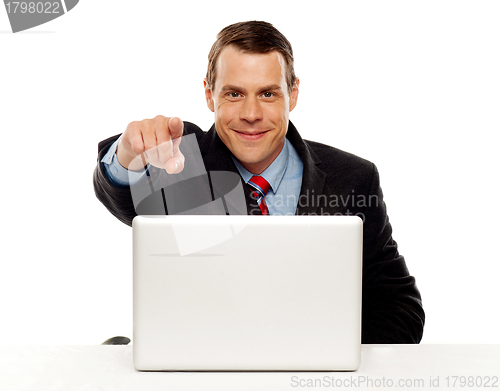 Image of Handsome male executive pointing at you