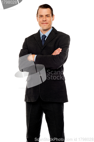 Image of Stylish young man posing with crossed arms