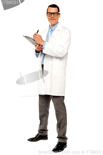 Image of Young physician writing medical report