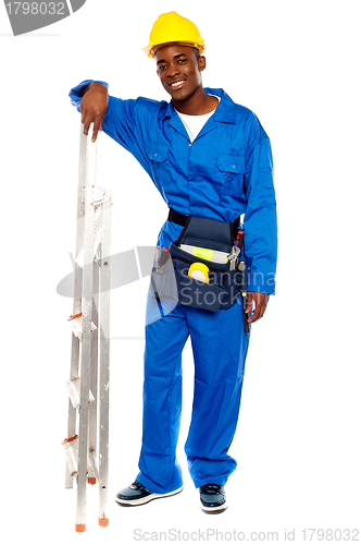 Image of Smiling african worker resting hand on stepladder