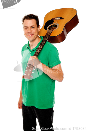 Image of Handsome casual man with guitar on shoulders