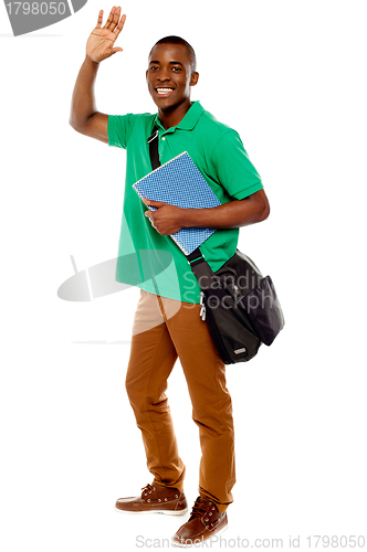 Image of Cheerful student waving his hands. Enjoying himself