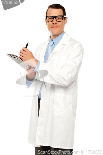 Image of Medical expert posing with report and pen