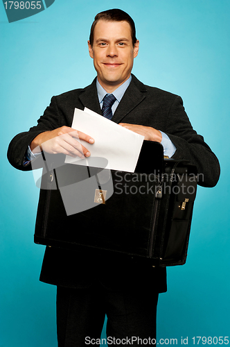 Image of Male executive arranging paper works