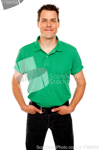 Image of Smiling guy posing with hands in jeans pocket