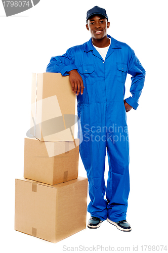 Image of Courier boy standing beside boxes