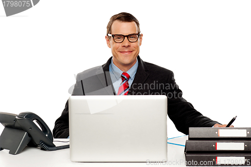 Image of Confident smiling male executive wearing glasses