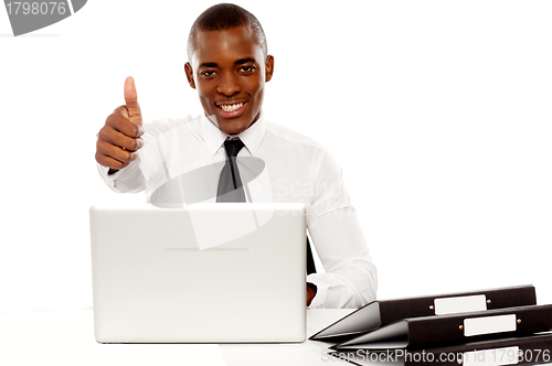 Image of Happy young african gesturing thumbs up
