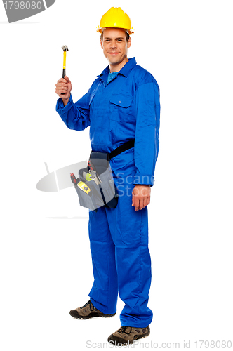 Image of Young construction worker holding hammer
