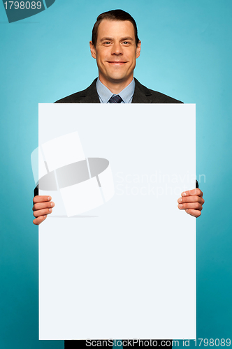 Image of Corporate man holding big white blank billboard