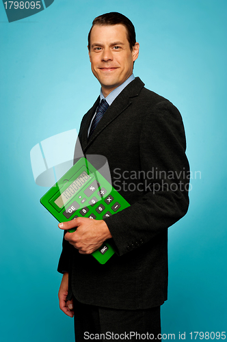 Image of Side view portrait of a businessman with calculator