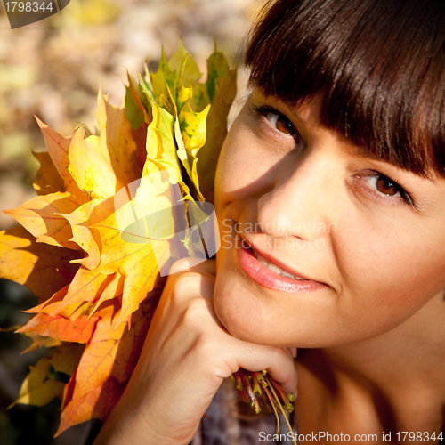 Image of woman with autumn leaves