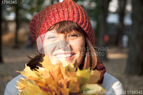 Image of woman with autumn orange leaves