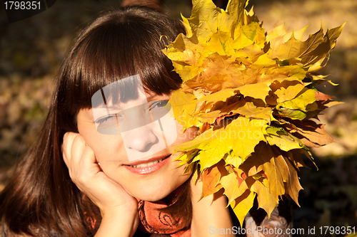 Image of woman with autumn leaves