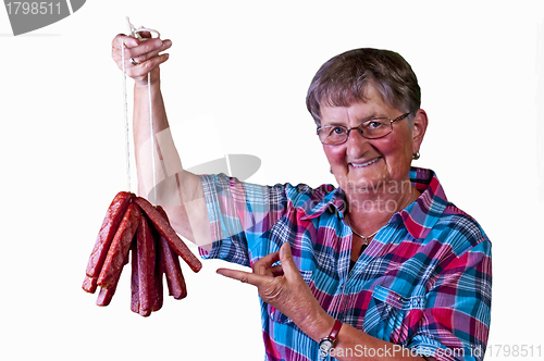 Image of female butcher with smoked sausage