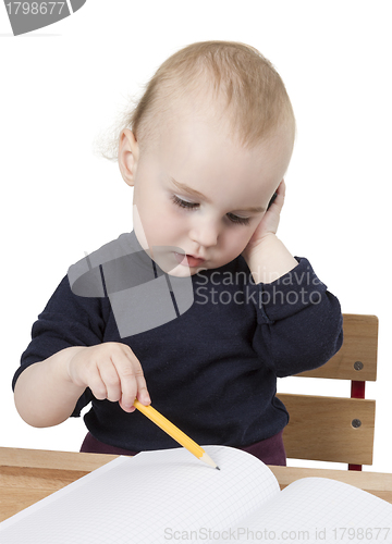 Image of young child at writing desk