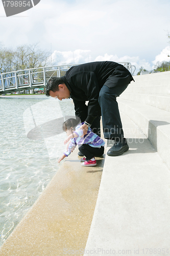 Image of Father and daughter playing in the park at spring in Ouchy, Swit