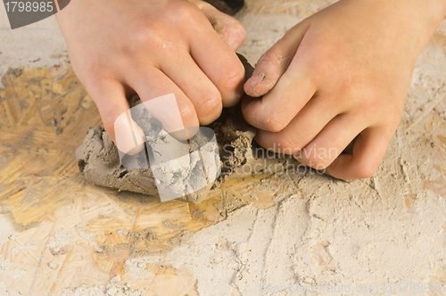 Image of Child hands of a potter