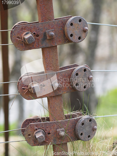 Image of Rusty steel wire fence and tensioner, Scotland.