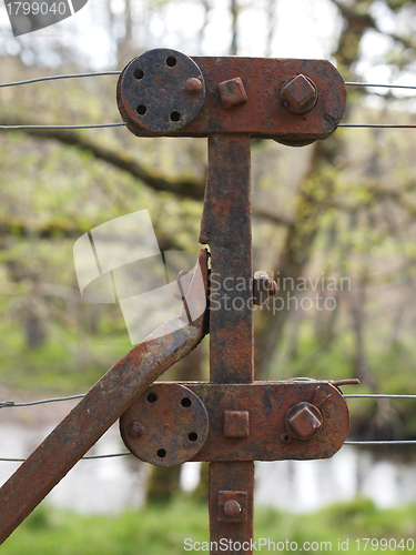 Image of Rusty steel wire fence and tensioner, Scotland.