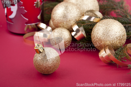 Image of beautiful golden christmas decoration on red background