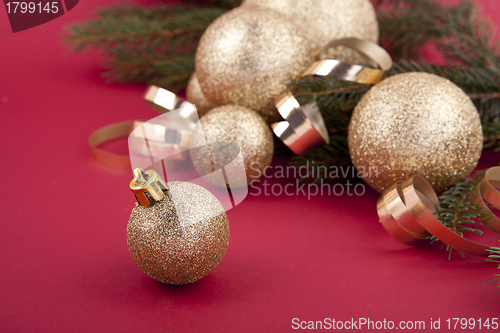 Image of beautiful golden christmas decoration on red background